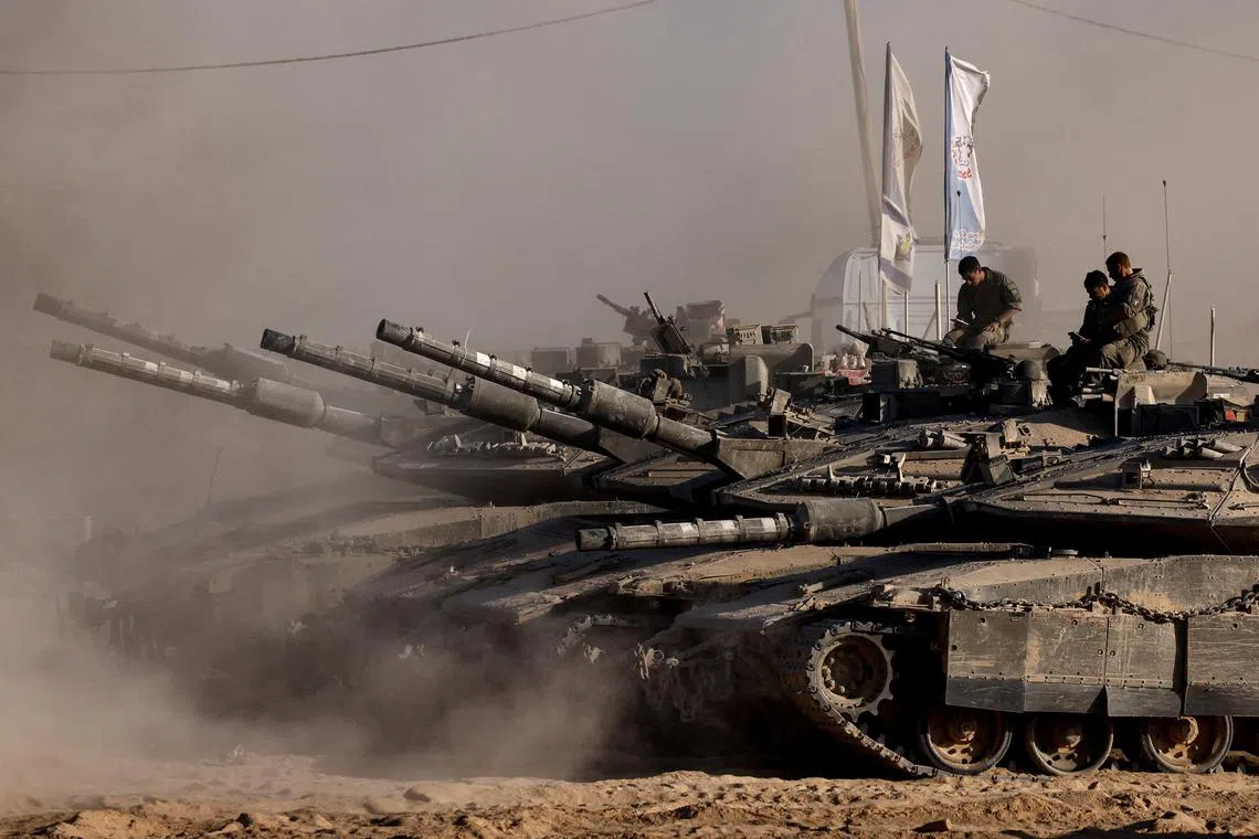 Israeli soldiers sit on top of tanks at the Israel-Gaza border, as seen from Israel, August 26, 2025. REUTERS/Amir Cohen