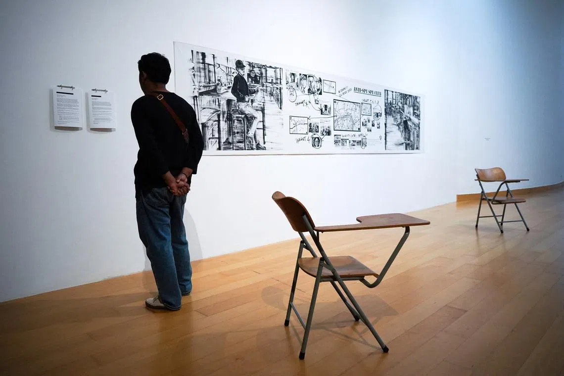 A man reads placards with artist names blacked out following censorship at the exhibition titled ‘Constellation of Complicity: Visualising the Global Machinery of Authoritarian Solidarity’, at the Bangkok Arts and Cultural Centre (BACC) in Bangkok, Thailand, August 7, 2025. REUTERS/Athit Perawongmetha