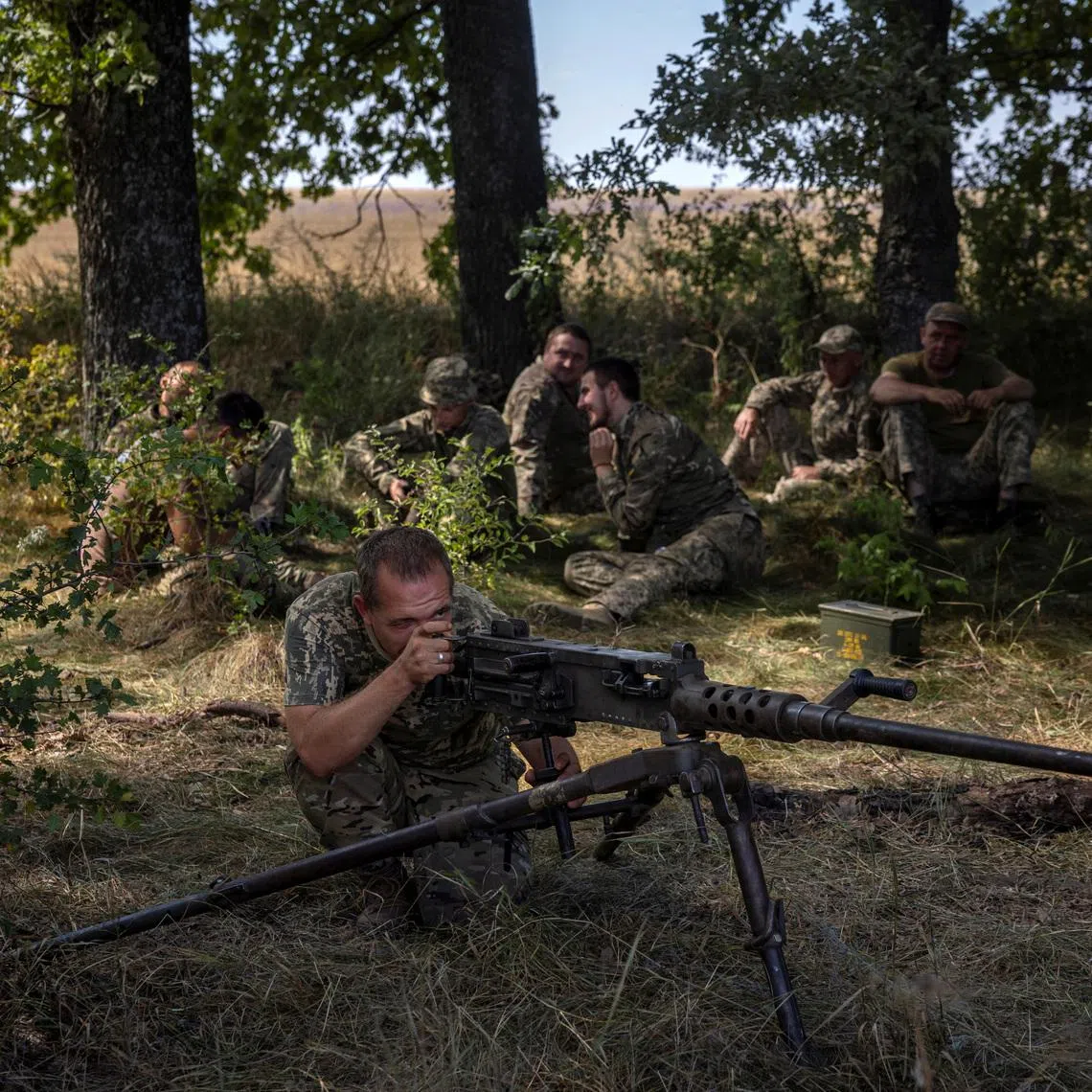 A soldier of Ukraine's 22nd Separate Mechanised Brigade aims a Browning M2 machine gun during an exercise in the Sumy region near the Russian border, amid Russia's attack on Ukraine, August 17, 2024.  REUTERS/Thomas Peter
