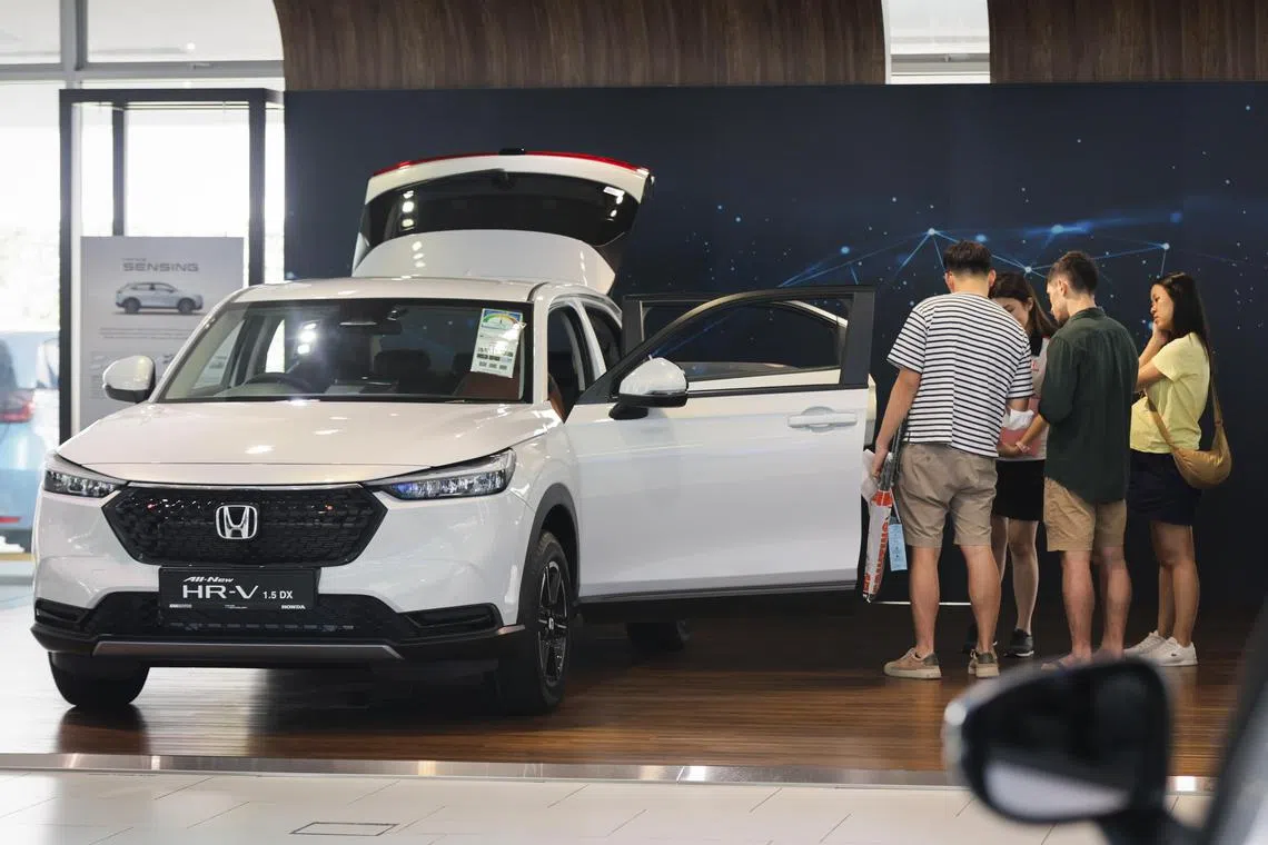 Visitors at the Kah Motor showroom checking out a Honda vehicle along Leng Kee Road on Saturday afternoon.