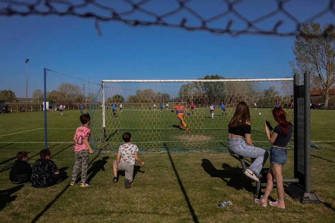 FILE PHOTO: People watch a local derby soccer match in the village of Ormenio, Greece, March 30, 2024. REUTERS/Louisa Gouliamaki/File Photo