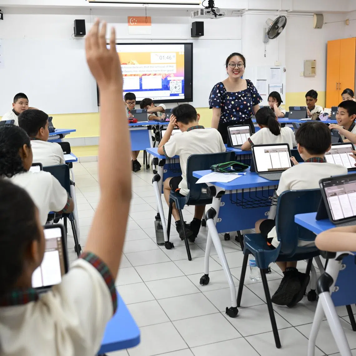 A Blangah Rise Primary School student raising her hand to offer feedback on a classmate's oratorical skills on March 2.