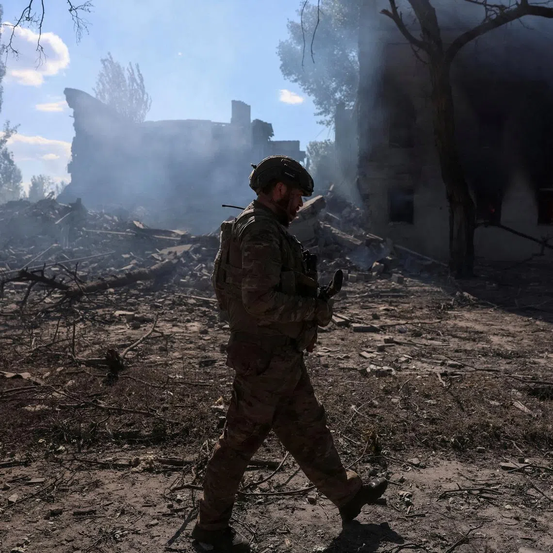 A serviceman of the 15th 'Kara-Dag' Brigade of the Operational Assignment of the National Guard of Ukraine walks near destroyed apartment buildings during his combat mission, amid Russia's attack on Ukraine, in the frontline town of Dobropillia, in Donetsk region, Ukraine June 28, 2026. REUTERS/Anatolii Stepanov