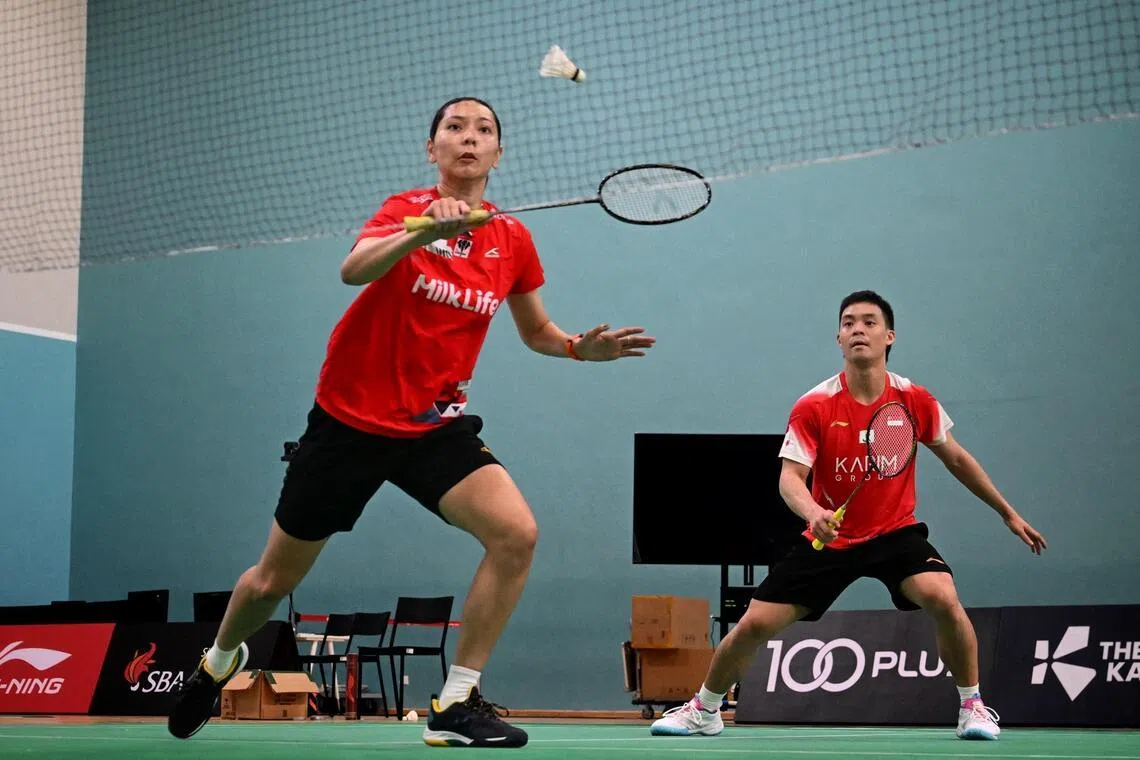 Indonesian badminton player Gloria Widjaja (left) and Singapore's Terry Hee training at the OCBC Arena on Jan 12.