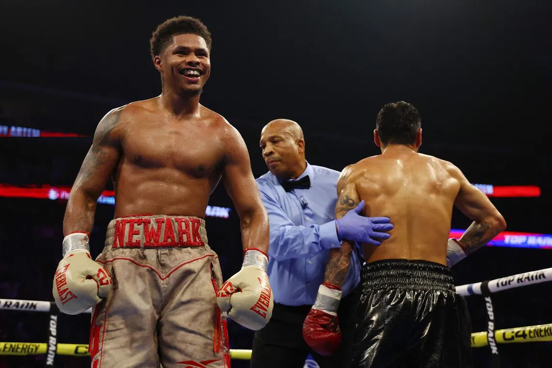 Shakur Stevenson (gold gloves) reacting against Artem Harutyunyan of Germany (red gloves) during their WBC Lightweight world title fight at Prudential Center on July 6 in Newark, New Jersey.