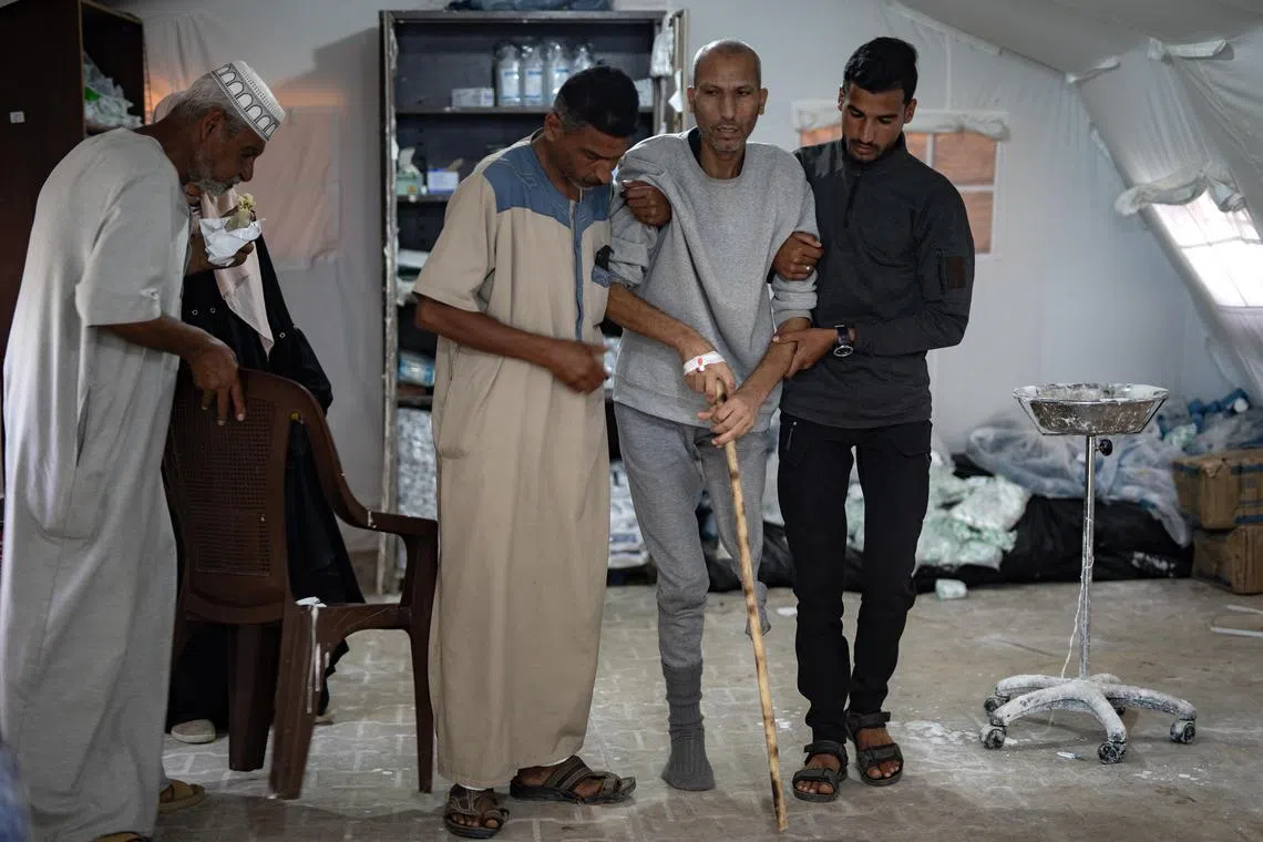 Palestinian prisoner released by the Israeli army Sufyan Abu Salah (second from left), arrives for medical examination at Al-Najjar Hospital, in Rafah on April 15. 
