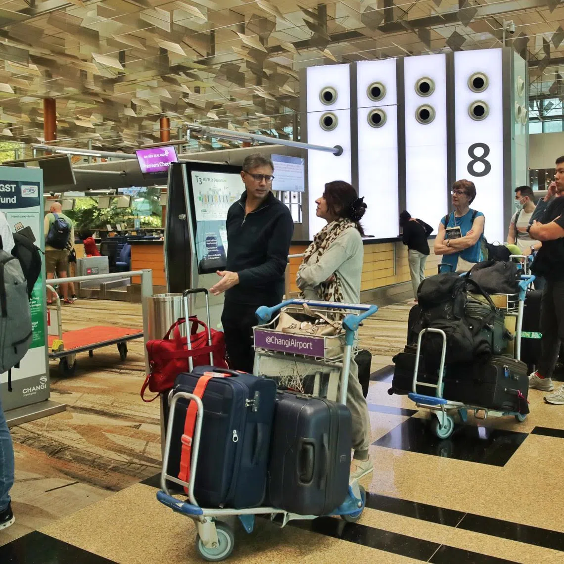 Passengers queueing to check-in for flight NZ283 to Auckland at Changi Airport Terminal 3 on Jan 31, 2023.