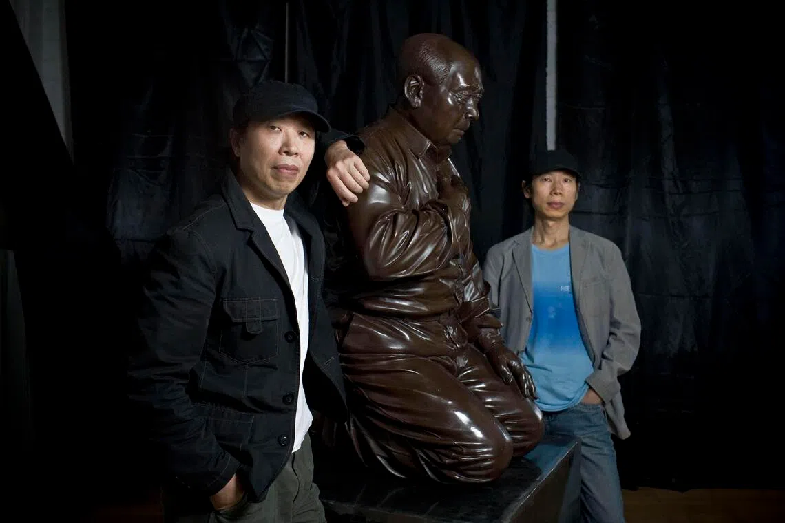 Gao Zhen (left) and his brother Gao Qiang with their artwork, titled Mao’s Guilt, in Beijing in 2009.