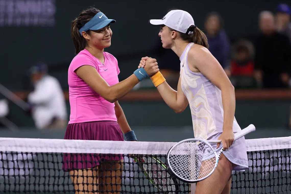 Emma Raducanu (left) congratulates Iga Swiatek after the latter's win at to advance to the quarter-finals at Indian Wells.