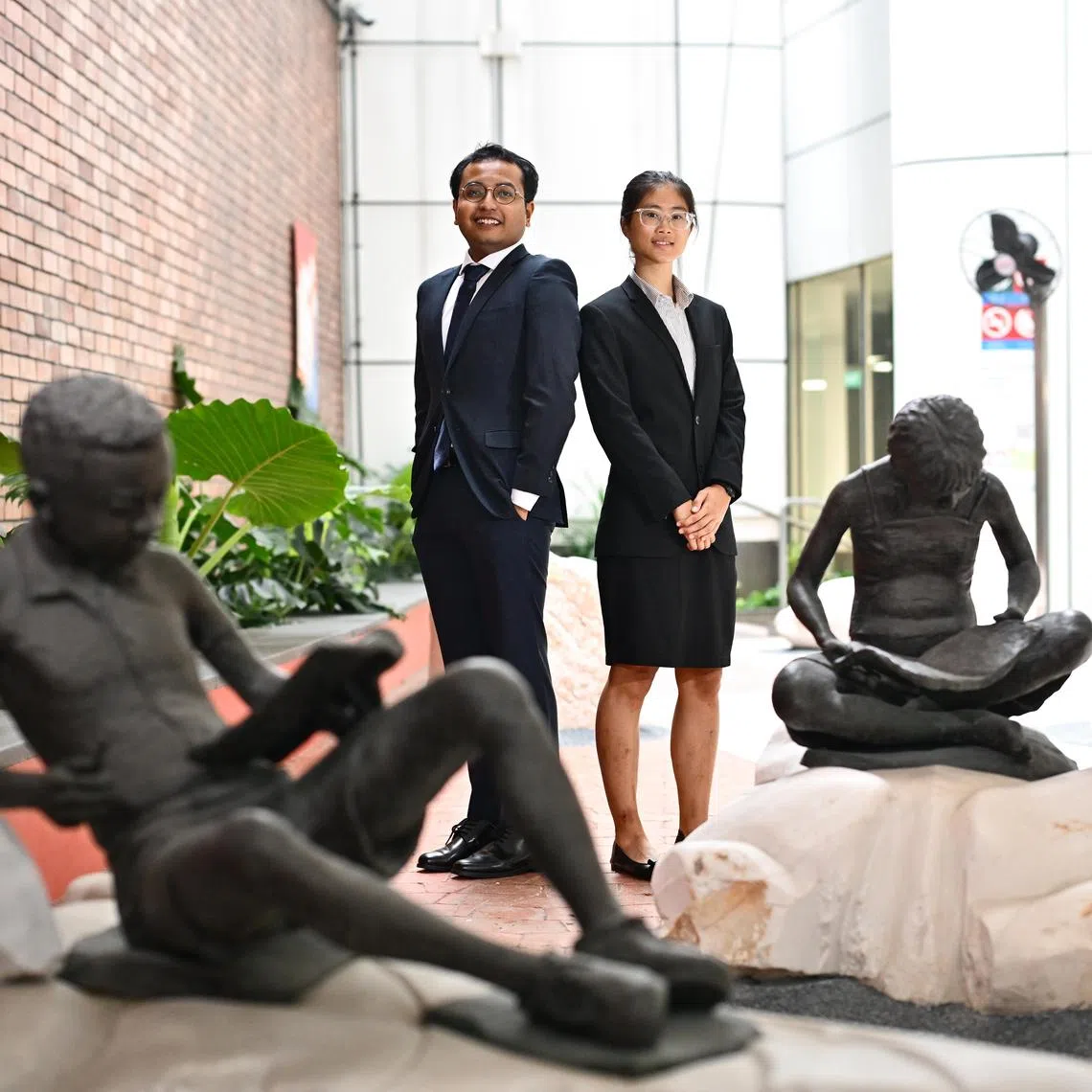 Mr Mohammed Aizam Bin Abd Rahman, 25, and Ms Ko Wen Hui Judith, 22, both 2024 PSC Scholarship recipients, inside the Central Public Library at National Library Building on July 16, 2024.

(ST PHOTO: LIM YAOHUI)