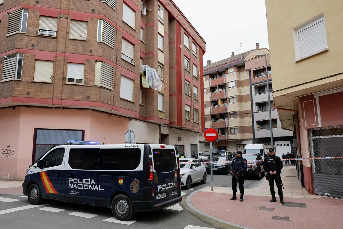 Spanish police officers stand guard outside a building after the arrest of a man suspected of being the sender of letter-bombs in November and December to the Ukrainian and US embassies and several institutions in Spain, in Miranda de Ebro, Spain, on Jan 25, 2023. 