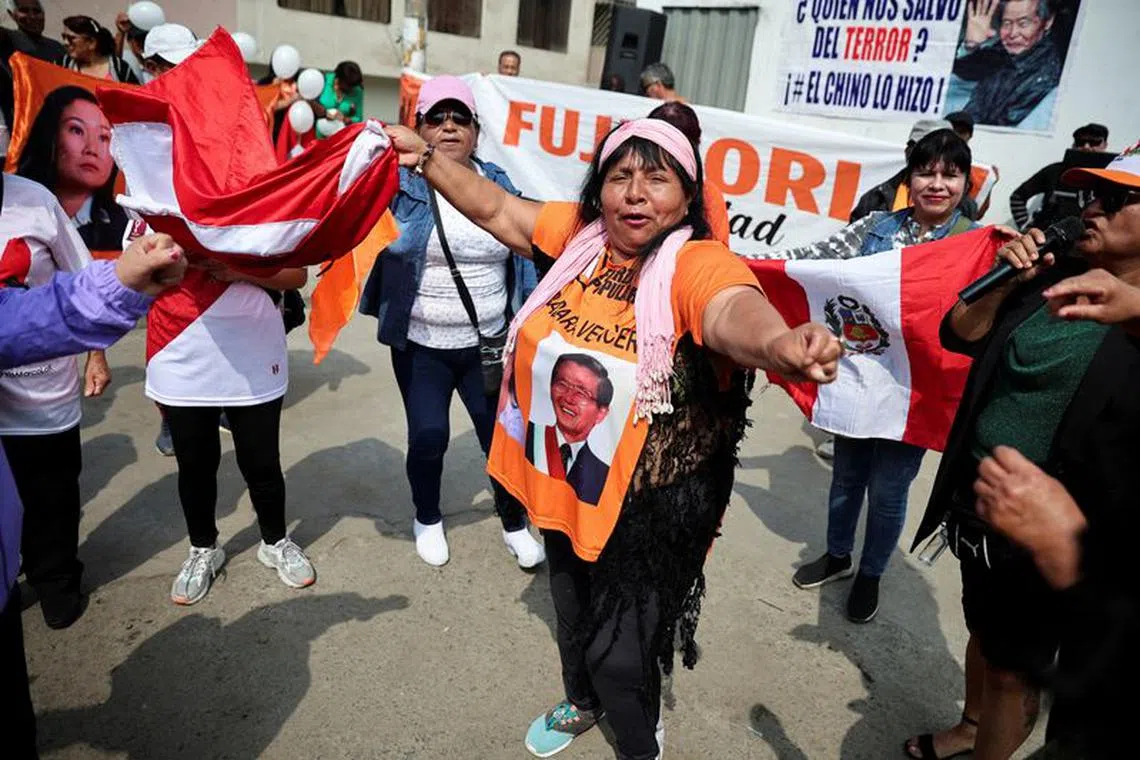 FILE PHOTO: People protest outside the prison where Peru's former President Alberto Fujimori is being held, in Lima, Peru December 6, 2023. REUTERS/Sebastian Castaneda/File Photo