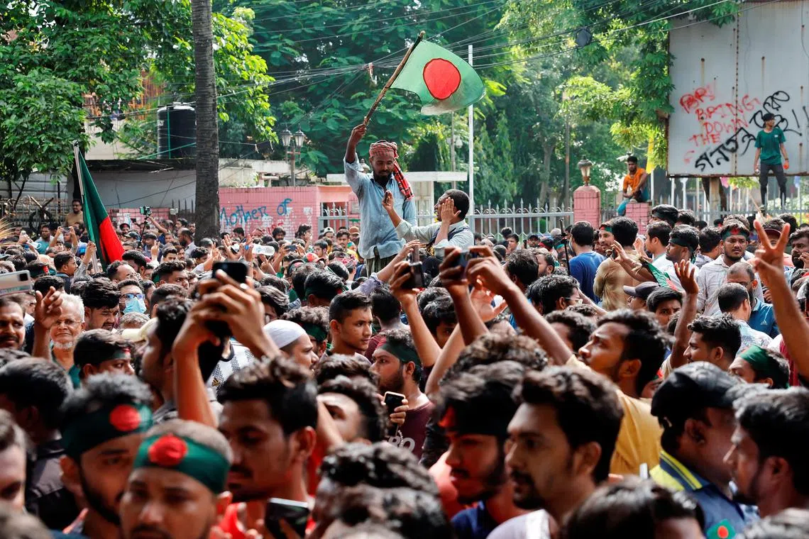 People celebrate the resignation of Bangladeshi Prime Minister Sheikh Hasina in Dhaka on Aug 5.