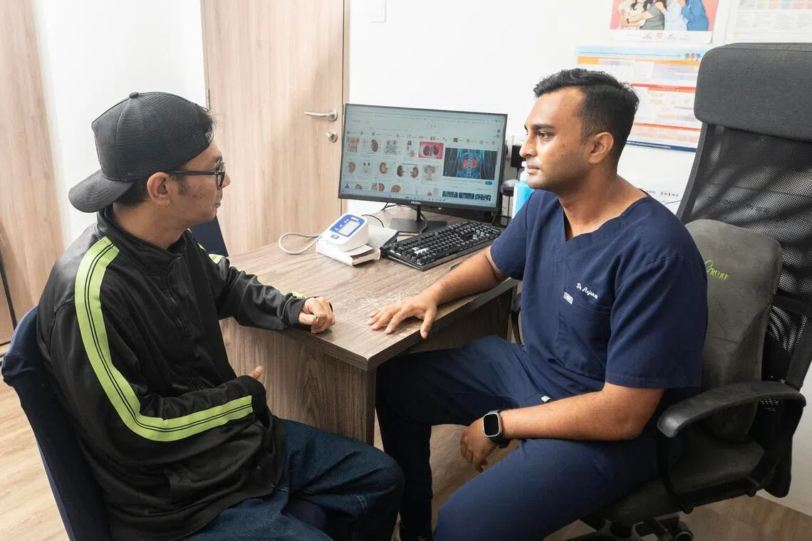 Dr Arjunan Kumaran, 34, with his patient, Mr Syafic Bin Omar, 40, at Intemedical Tampines on Oct 28.