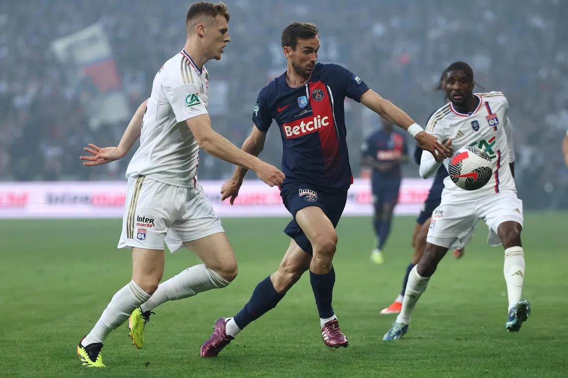 Lyon's Irish defender Jake O'Brien (left) and Paris Saint-Germain's Spanish midfielder Fabian Ruiz fight for the ball in the French Cup final at the Stade Pierre-Mauroy in Lille on May 25, 2024. O'Brien scored Lyon's goal in their 2-1 loss.