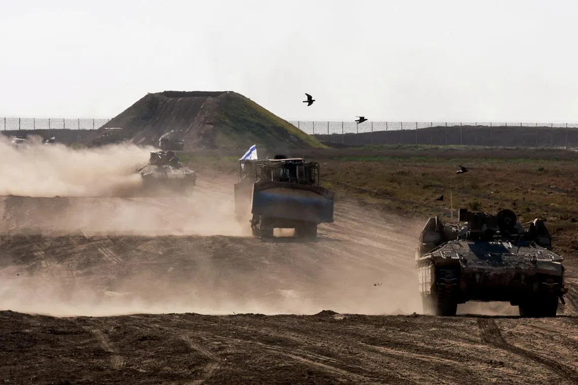 Military vehicles maneuvre near the Israel-Gaza border fence, amid the ongoing conflict between Israel and the Palestinian Islamist group Hamas, in Israel, March 4, 2024. REUTERS/Ammar Awad/File Photo