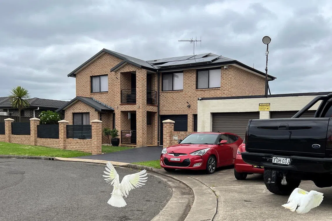 Cars park outside a house in Casula in the outer suburbs of Sydney, Australia, February 25, 2025. REUTERS/Kirsty Needham