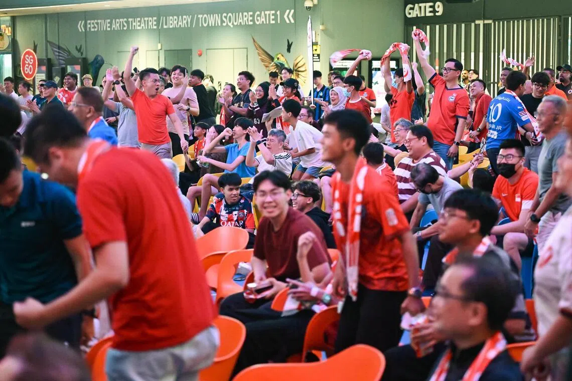 Fans react as Singapore score a goal during the watch party organised by the Football Association of Singapore for the winners-take-all Asian Cup qualifier between Hong Kong and Singapore at Our Tampines Hub on Nov 18, 2025. Singapore won 2-1 against Hong Kong.