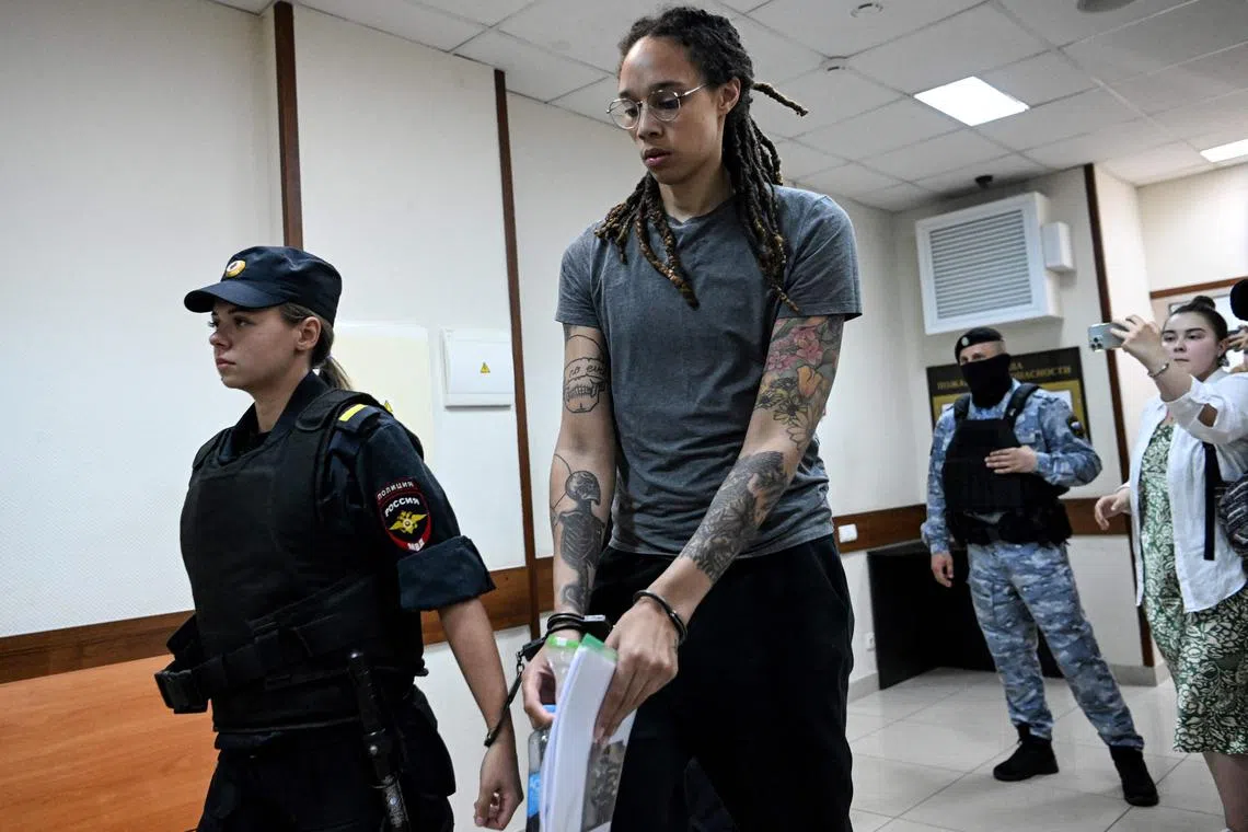 (FILES) In this file photo taken on August 4, 2022 US Women National Basketball Association's (WNBA) basketball player Brittney Griner, who was detained at Moscow's Sheremetyevo airport and later charged with illegal possession of cannabis, leaves the courtroom before the court's final decision in Khimki outside Moscow. - Basketball star Brittney Griner has been sent to a remote Russian penal colony and has started serving her sentence, her lawyers said on November 17, 2022. (Photo by Kirill KUDRYAVTSEV / POOL / AFP)