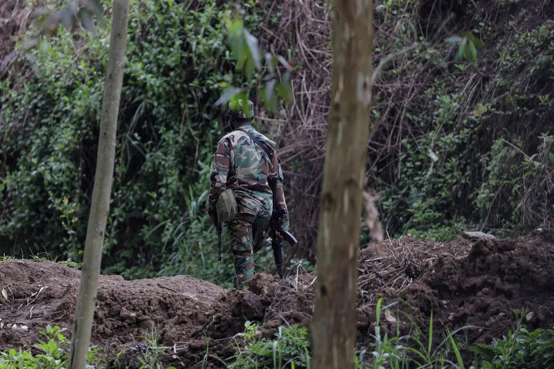 FILE PHOTO: An M23 rebel walks on the outskirts of Matanda which is controlled by M23 rebels, in eastern Democratic Republic of Congo, March 22, 2025. REUTERS/Zohra Bensemra/File Photo