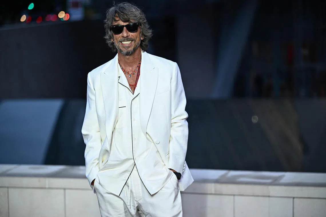 Italian fashion designer Pierpaolo Piccioli poses on the red carpet as he arrives for 'The Prelude to the Olympics' at The Fondation Louis Vuitton in Paris on July 25, 2024, ahead of the 2024 Paris Olympics. 