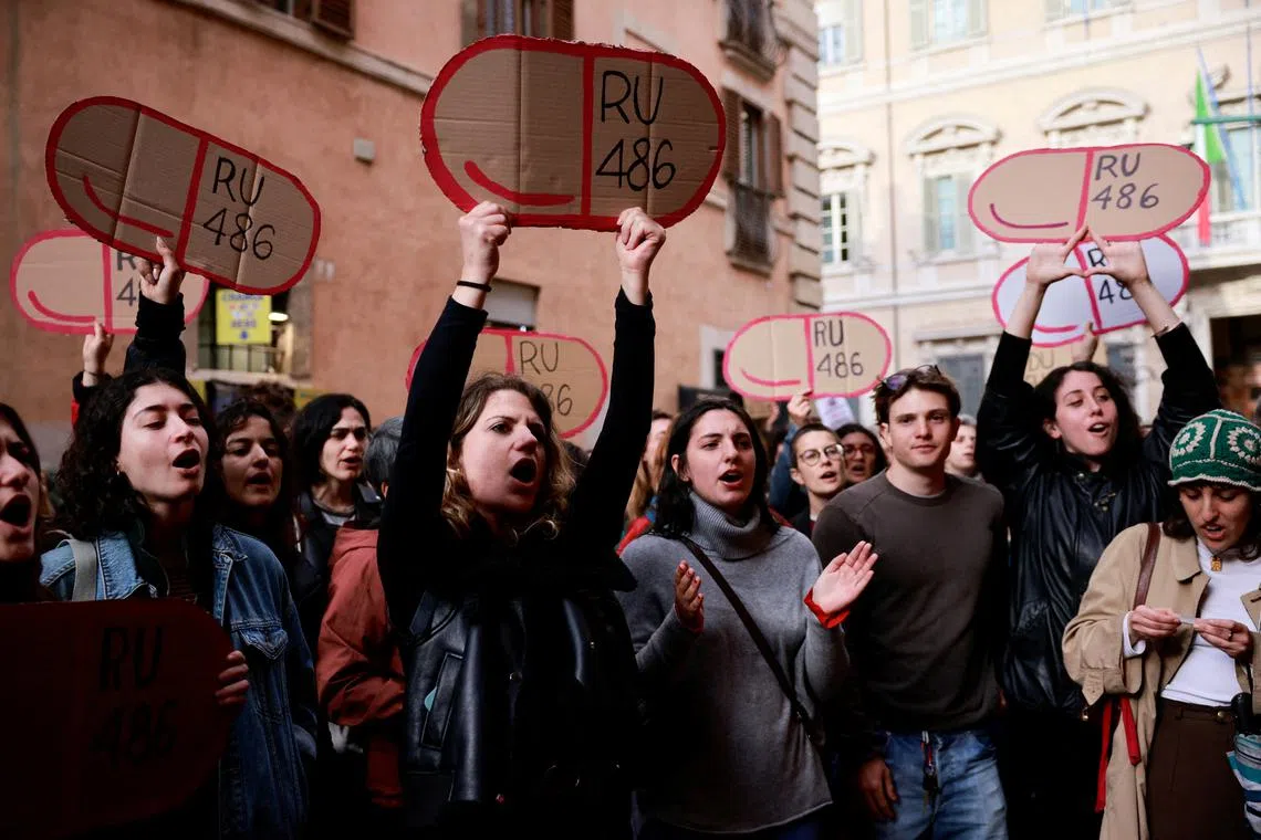 FILE PHOTO: Women hold cardboard cutouts of RU-486 (abortion pill mifepristone) as they demonstrate outside Madama Palace (Senate) against a parliamentary amendment that could make it easier for anti-abortion groups to operate in publicly-run family clinics, in Rome, Italy, April 22, 2024. REUTERS/Yara Nardi/File Photo