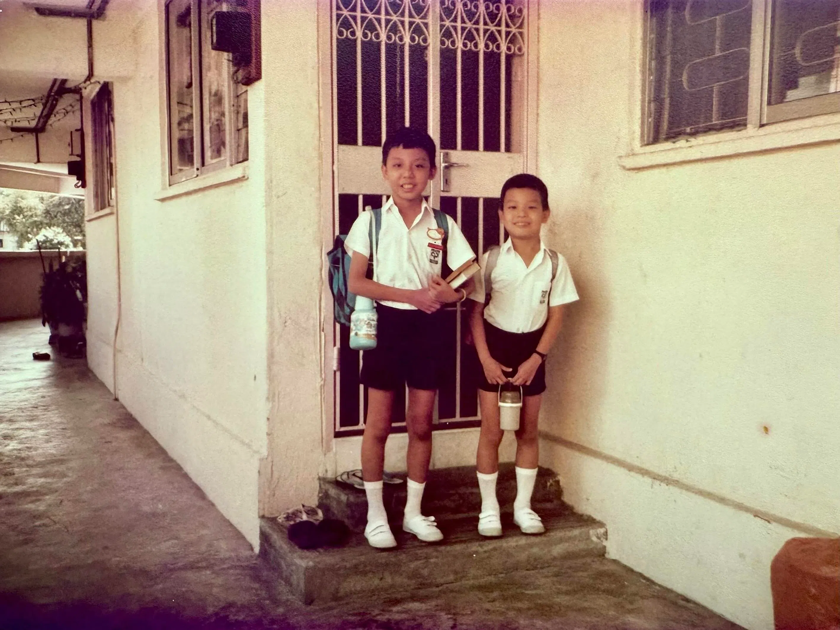 The young Jeffrey Siow with his younger brother outside their flat in Potong Pasir.
