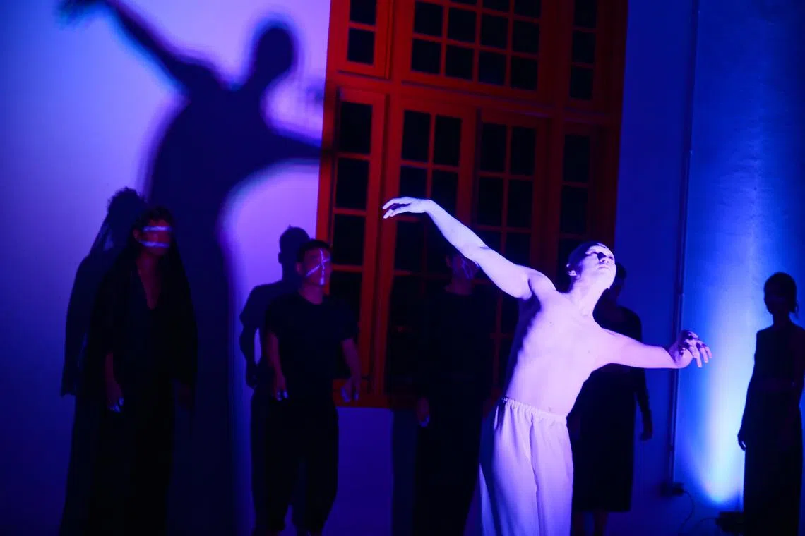 Butoh dancer Norihito Ishii (right), of Sankai Juku, performing with some 15 local dancers at a Singapore Butoh Collective showcase at the Stamford Arts Centre on Oct 10, after a workshop.

