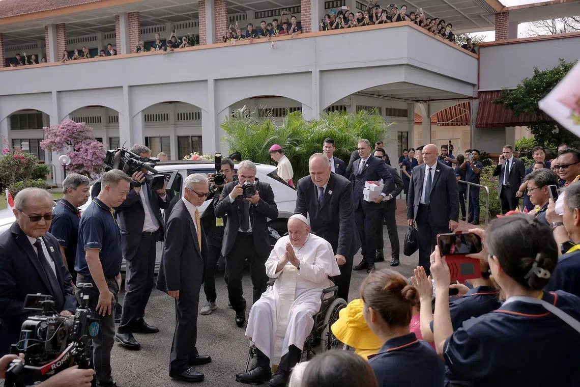 Pope Francis gestures as he takes his leave after meeting and blessing elderly and sick residents at St Theresa's Home on Sept 13, 2024. ST PHOTO: KEVIN LIM pixpope13