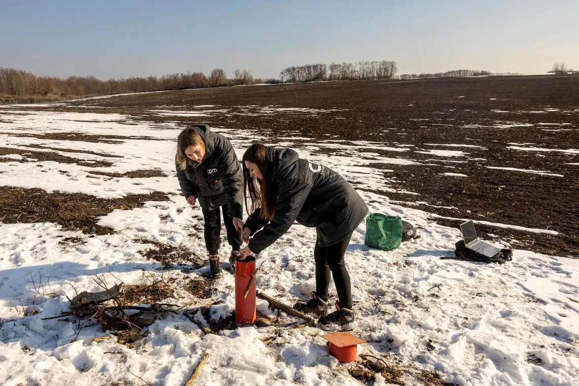 Environmental experts Yuliia Zazerina and Alina Tatarchuk testing the groundwater level at the Polokhivske lithium deposit that will be developed by UkrlithiumMining, in Ukraine’s Kirovograd region, on Feb 27.