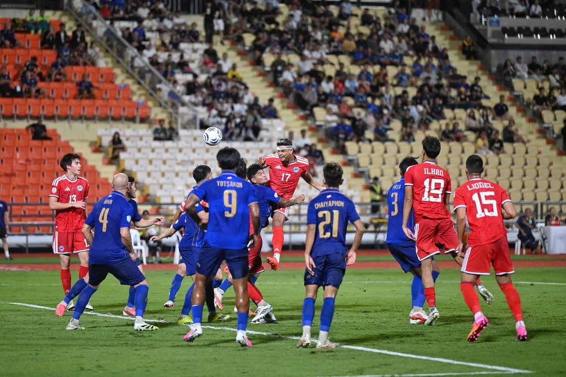 Singapore’s Irfan Fandi (No. 17) attempting a header against Thailand during their ASEAN Championship semi-final second leg on Aug 18.