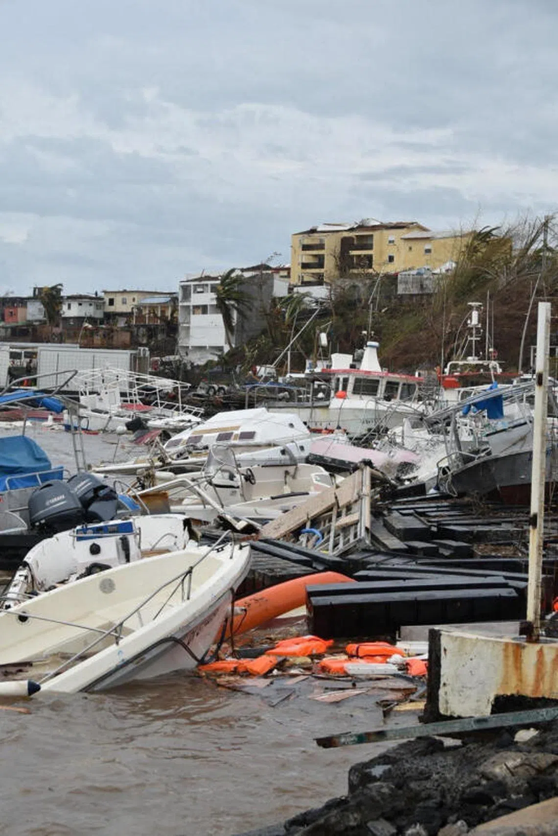 Damaged boats and debris pile up on a shore, in the aftermath of Cyclone Chido, in Mayotte, France, in this handout image obtained by Reuters on December 16, 2024. Ministere de lÕInterieur/Handout via REUTERS THIS IMAGE HAS BEEN SUPPLIED BY A THIRD PARTY. NO RESALES. NO ARCHIVES