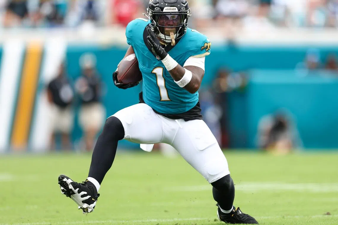 FILE PHOTO: Oct 6, 2024; Jacksonville, Florida, USA; Jacksonville Jaguars running back Travis Etienne Jr. (1) runs with the ball against the Indianapolis Colts in the first quarter at EverBank Stadium. Mandatory Credit: Nathan Ray Seebeck-Imagn Images/File Photo