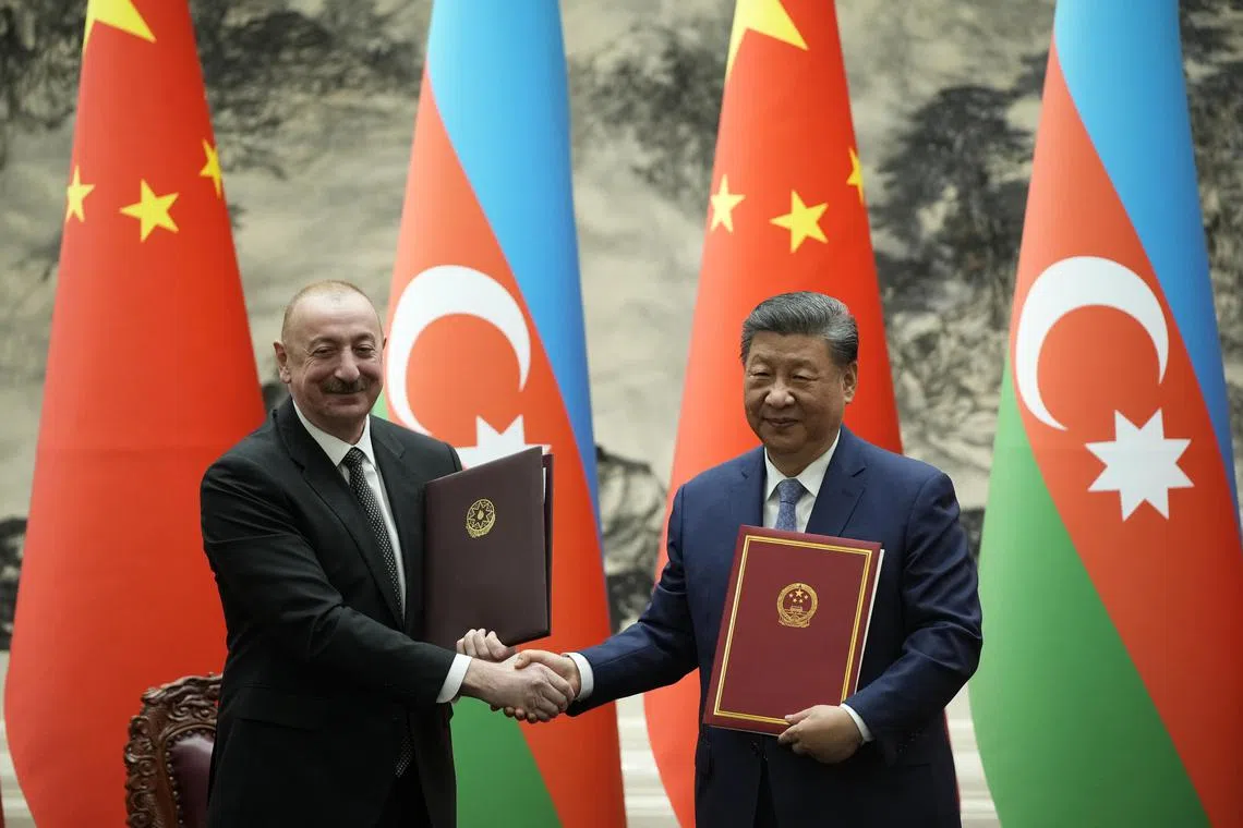 Chinese President Xi Jinping (R) and Azerbaijan President Ilham Aliyev shaking hands during a signing ceremony at The Great Hall of The People in Beijing, China.