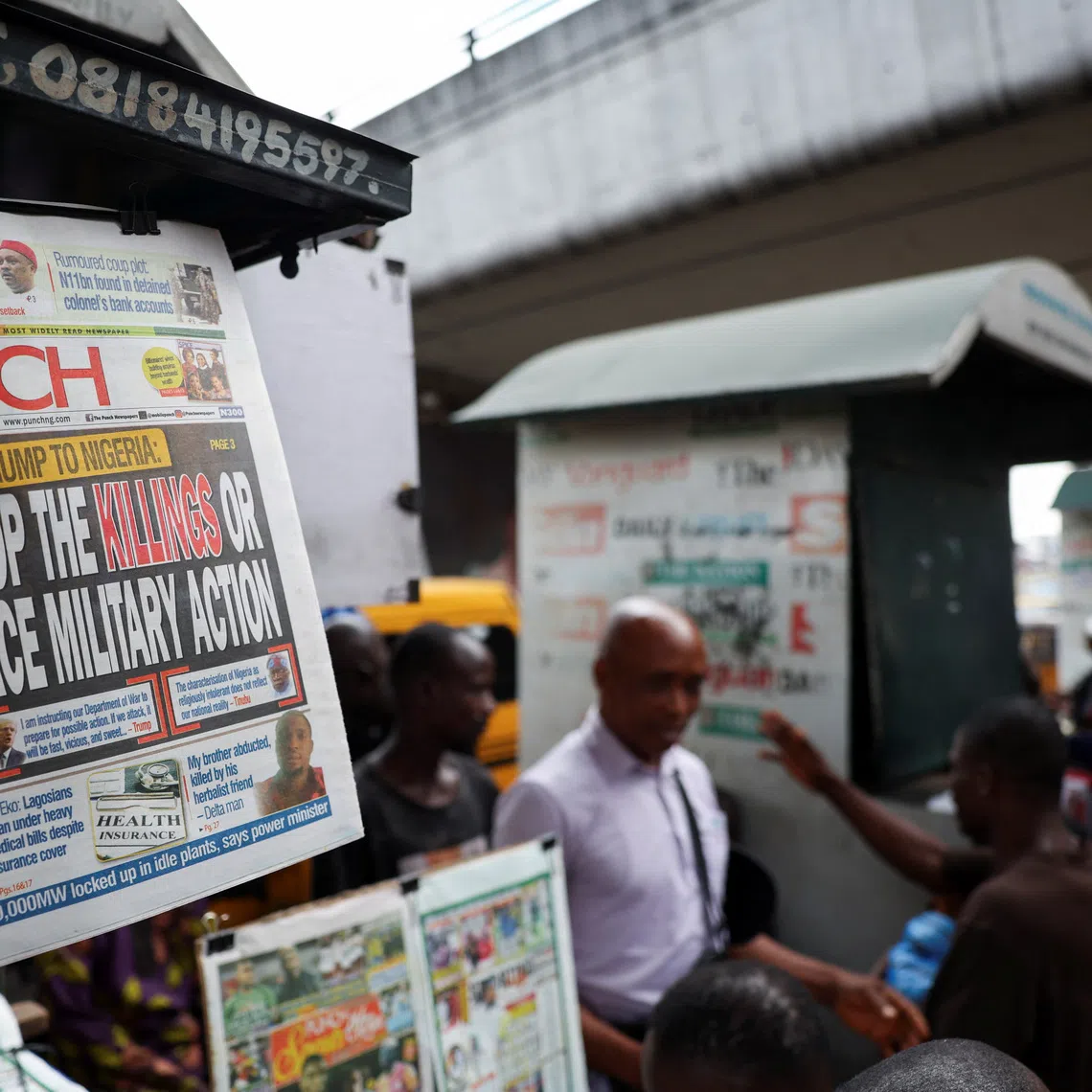 A newspaper with an article reporting U.S. President Donald Trump's message to Nigeria over the treatment of Christians hangs at a newspaper stand in Ojuelegba, Lagos, Nigeria. November 2, 2025. REUTERS/Sodiq Adelakun