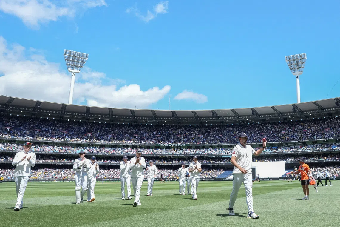 Cricket - The Ashes - Australia v England - Fourth Test -  MCG, Melbourne, Australia - December 26, 2025 England's Josh Tongue walks off the field raising the ball after claiming 5 wickets. REUTERS/Asanka Brendon Ratnayake