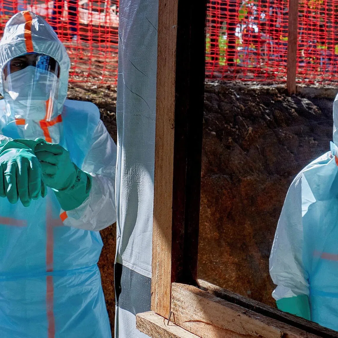 Health workers fighting the Ebola virus in the Democratic Republic of Congo get dressed in personal protective equipment.
