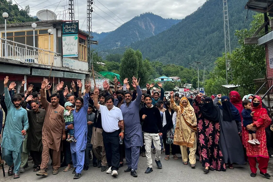 FILE PHOTO: People chant slogans as they walk during a protest and shutter-down strike called by the banned Joint Awami Action Committee (JAAC), an alliance of civil society groups, in Neelum Valley, Pakistani Kashmir, June 21, 2026. Picture taken with a mobile phone. REUTERS/Naseer ud Din/File Photo