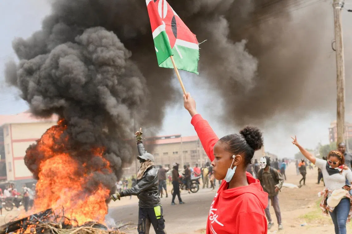 A demonstrator holds a Kenyan flag during a protest against a U.S.-backed Ebola quarantine plan on the establishment of a 50-bed facility at a Kenyan air force base that was intended to host Americans exposed to Ebola, in Nanyuki town, in Laikipia County, Kenya June 1, 2026. REUTERS/John Muchucha
