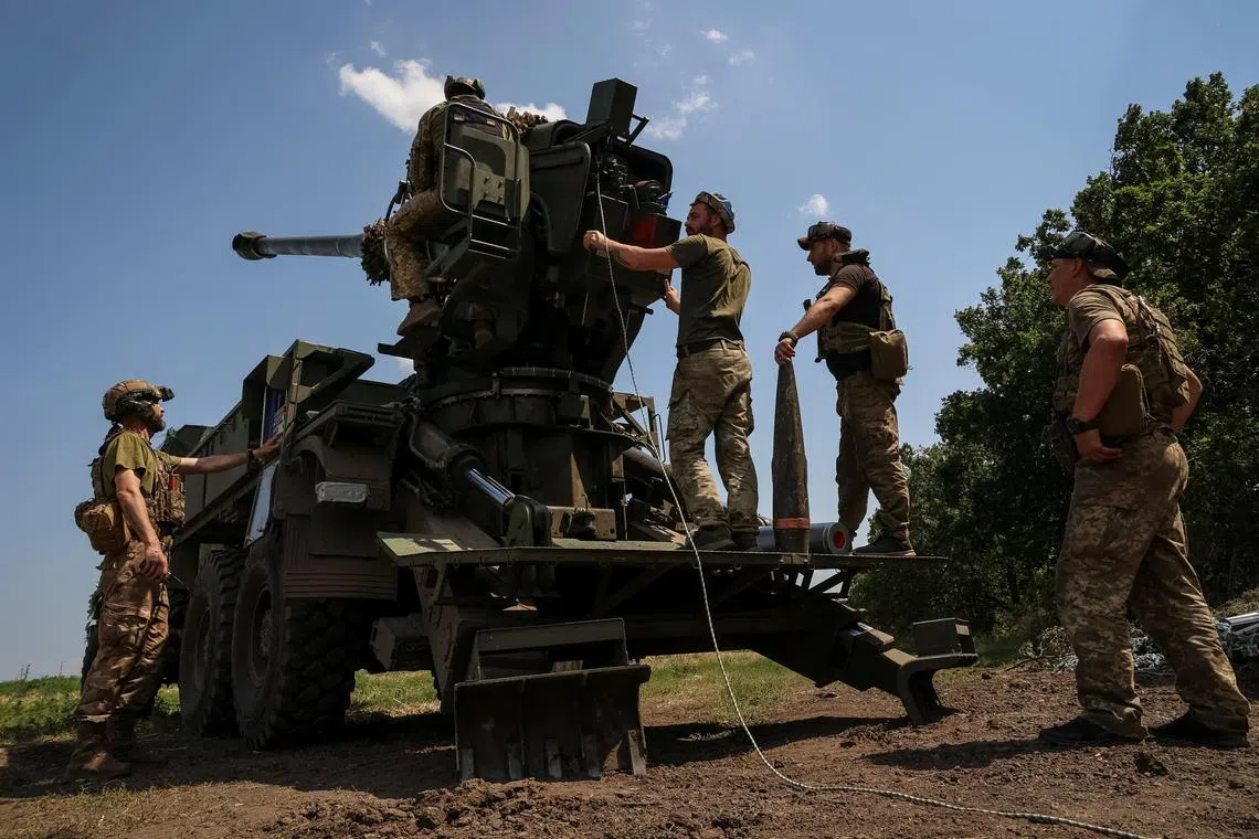 Ukrainian servicemen prepare to fire a self-propelled howitzer towards Russian troops, at a position near the city of Bakhmut.