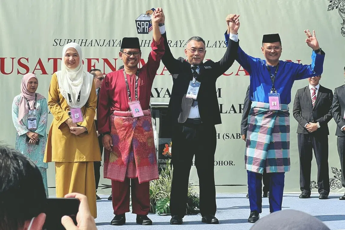 Larkin candidates Norsinah Abu (left) from Bersama, Pakatan Harapan’s Suhaizan Kayat (second from left) and Hairi Mad Shah (far right) from Barisan Nasional.