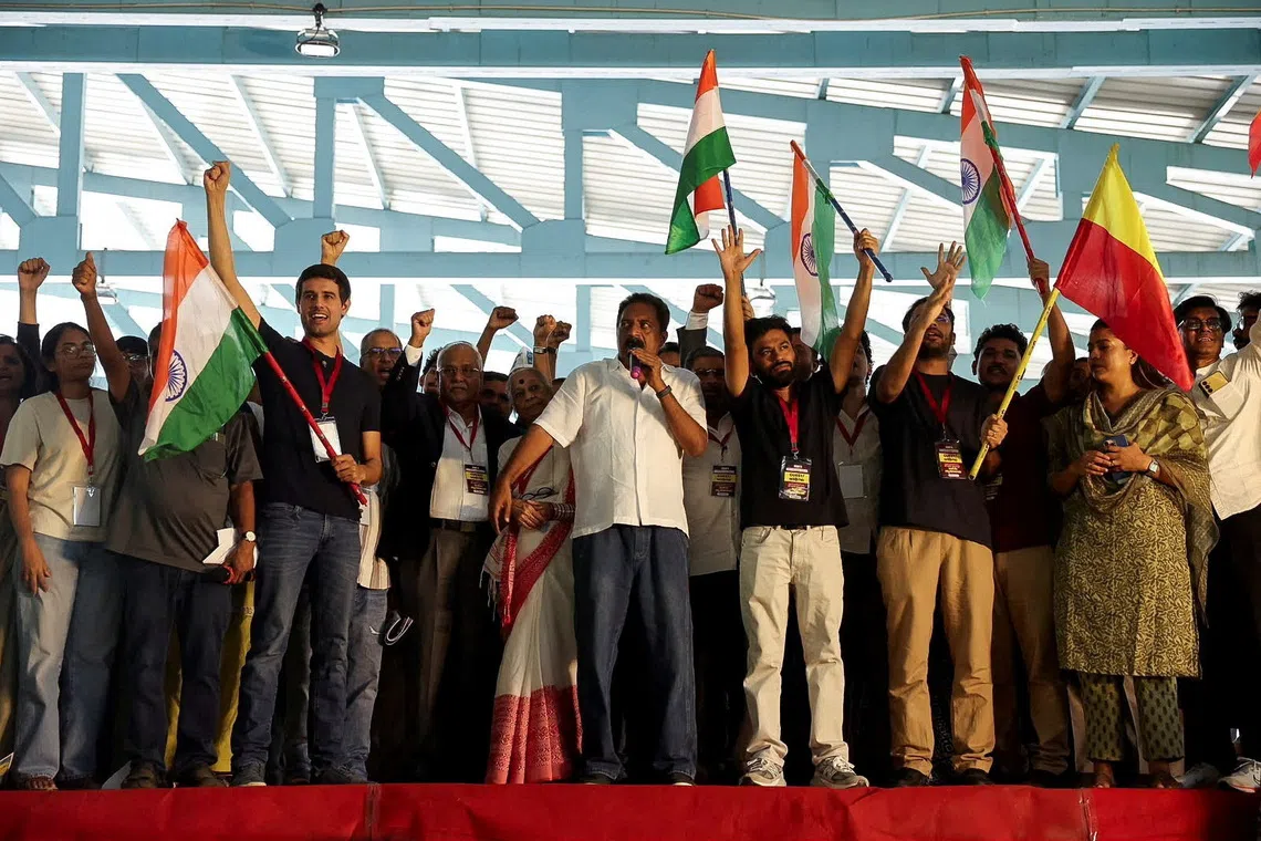 Indian social media influencer and activist Dhruv Rathee, Indian actor Prakash Raj, Cockroach Janta Party founder Abhijeet Dipke and other supporters gesture during a protest demanding the resignation of the country's election chief Gyanesh Kumar, in Bengaluru, India, October 8, 2026. REUTERS/Priyanshu Singh