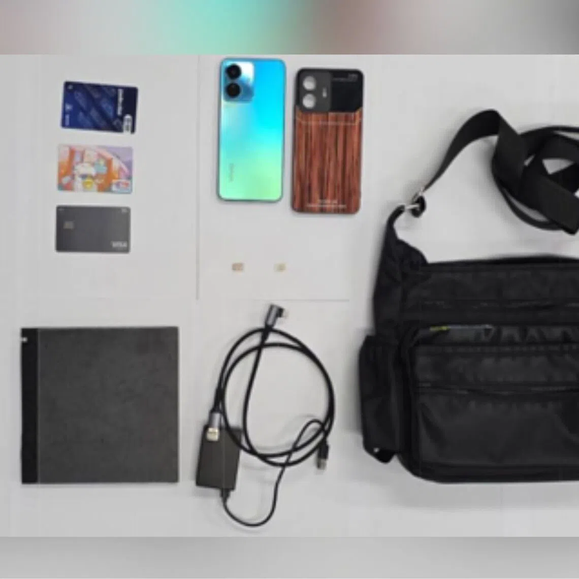 An electronic device, two power banks, a mobile phone and several bank cards were found in his possession and seized as case exhibits.