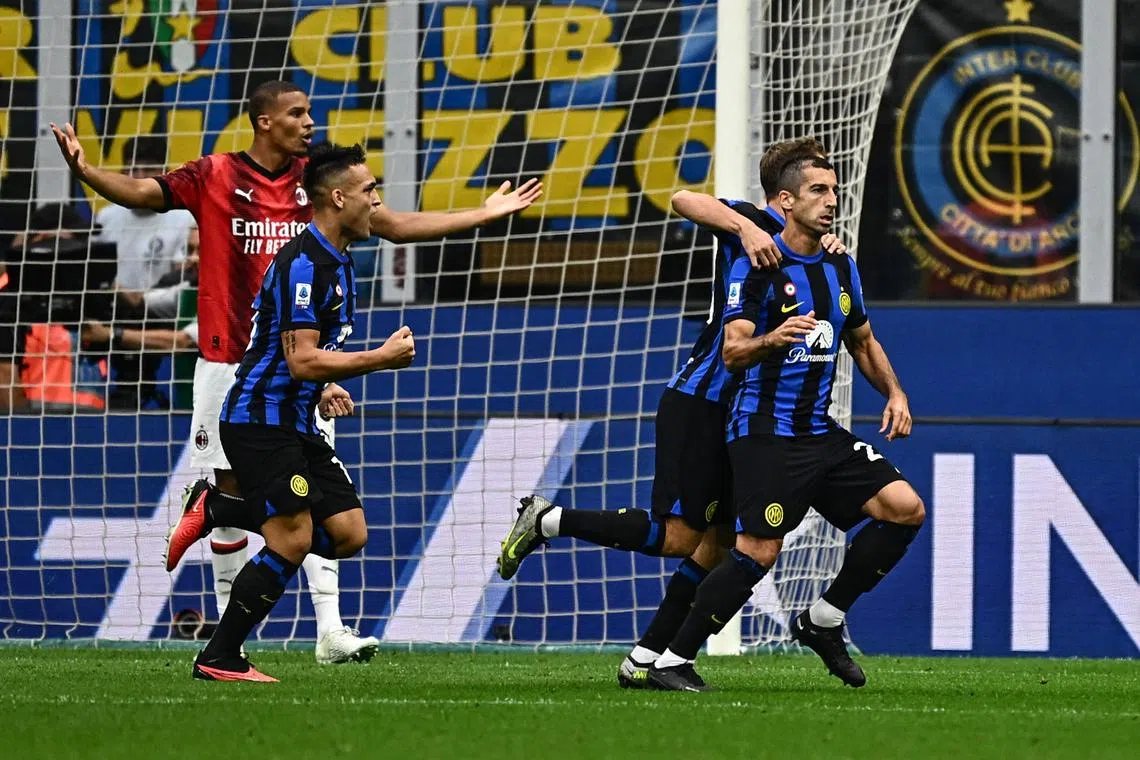 Inter Milan's Henrikh Mkhitaryan (right) celebrates scoring his team's first goal against AC Milan.
