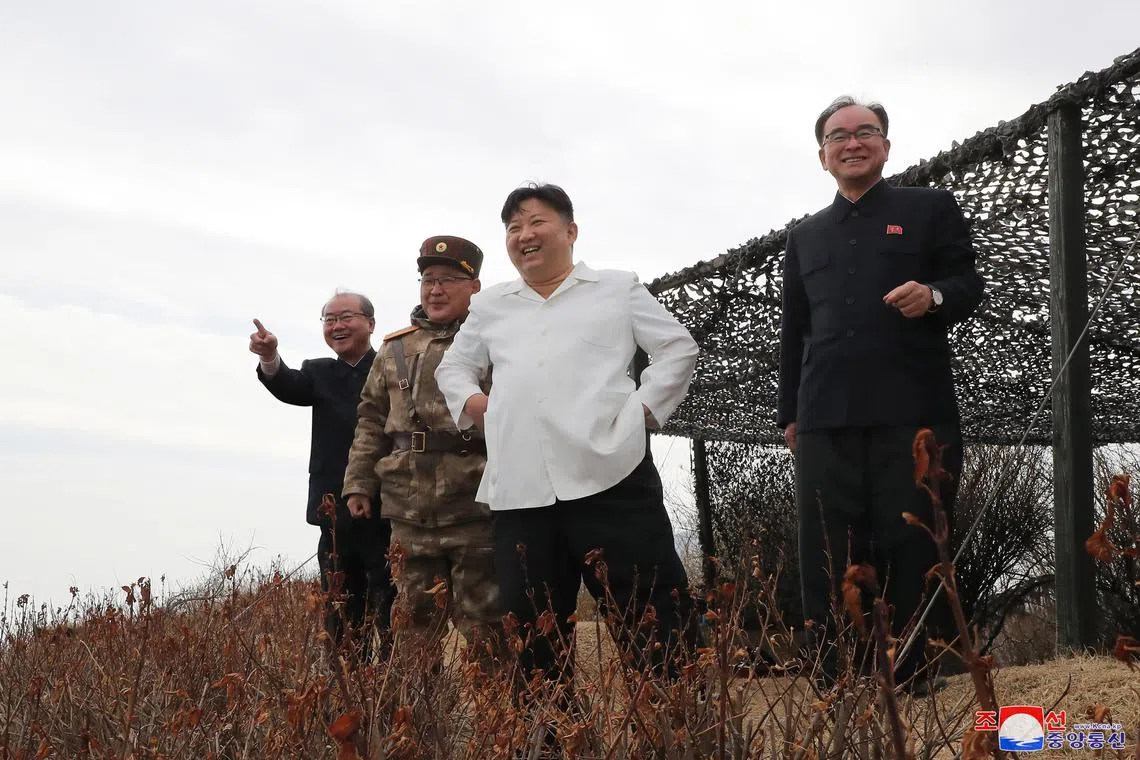 epa10539852 A photo released by the official North Korean Central News Agency (KCNA) shows North Korean Supreme Leader Kim Jong-un (2-R) observing a cruise missile exercise conducted in Jakdo-dong, South Hamgyong Province, North Korea, 22 March 2023 (issued 24 March 2023). According to North Korean state media, the test involved two Hwasai-1 and two Hwasai-2 strategic cruise missiles, equipped with a 'test warhead simulating a nuclear warhead.'  EPA-EFE/KCNA   EDITORIAL USE ONLY