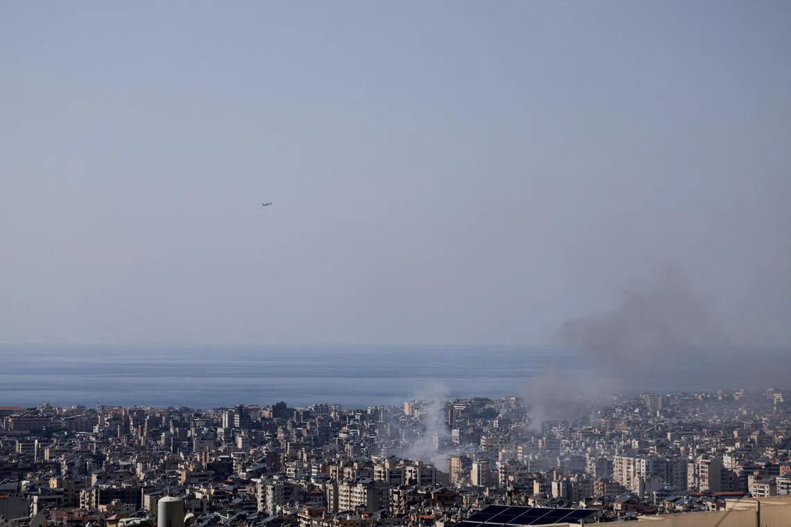 Smoke rises after an Israeli airstrike as a plane takes off from Rafik Hariri Airport, following an escalation between Hezbollah and Israel amid the US-Israeli conflict with Iran, in Beirut, Lebanon, on March 3, 2026.