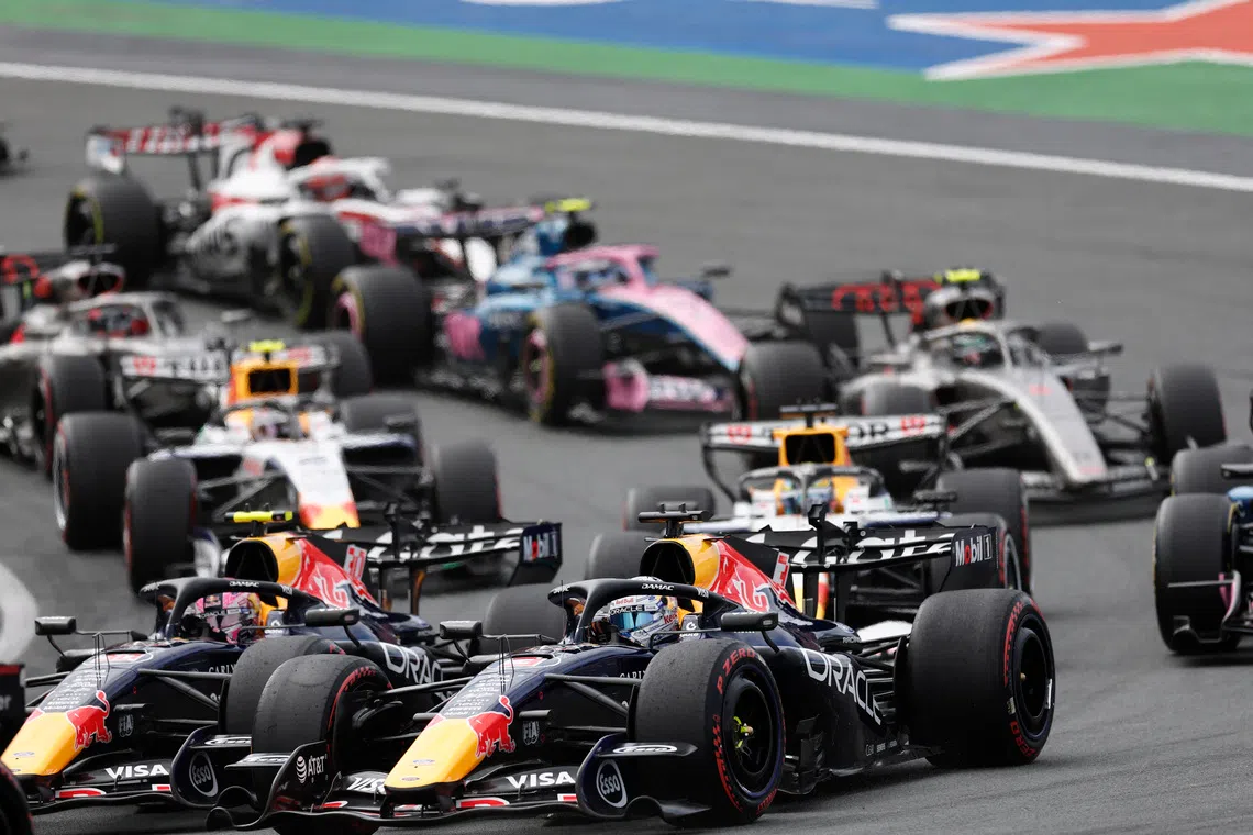 Formula One F1 - Dutch Grand Prix - Circuit Zandvoort, Zandvoort, Netherlands - August 23, 2026 Red Bull's Max Verstappen and Liam Lawson in action at the start of the race REUTERS/Benoit Tessier