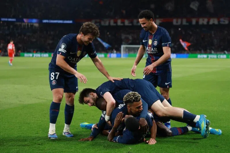 Paris St Germain's Ousmane Dembele celebrates scoring their fifth goal with teammates.