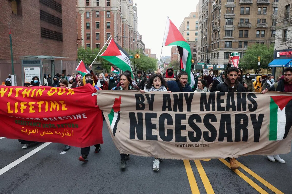 Demonstrators holding a banner protest in solidarity with Pro-Palestinian organizers as they block a street, amid the ongoing conflict between Israel and the Palestinian Islamist group Hamas, in New York City, U.S., April 18, 2024. REUTERS/Caitlin Ochs/File Photo