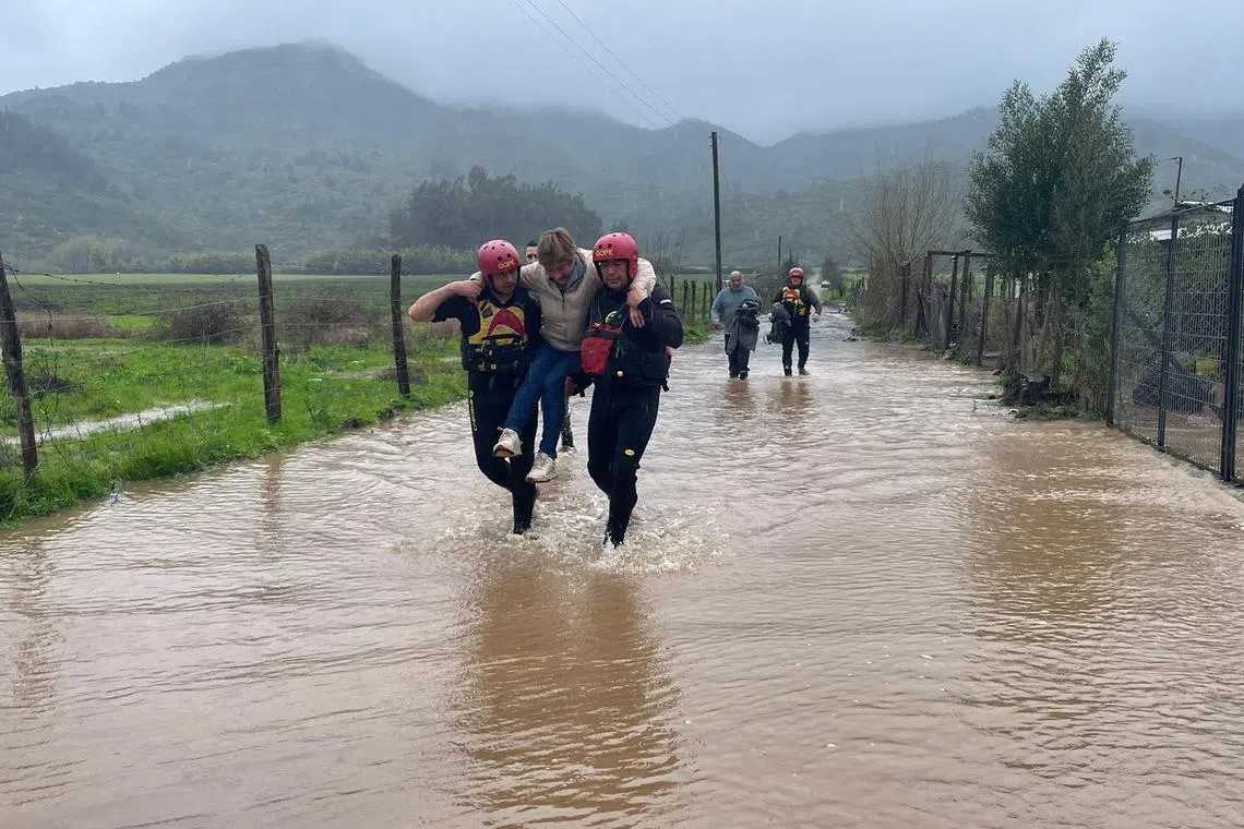 Local residents are evacuated from a flood as heavy rains hits Chile's central-south areas, Maule region.